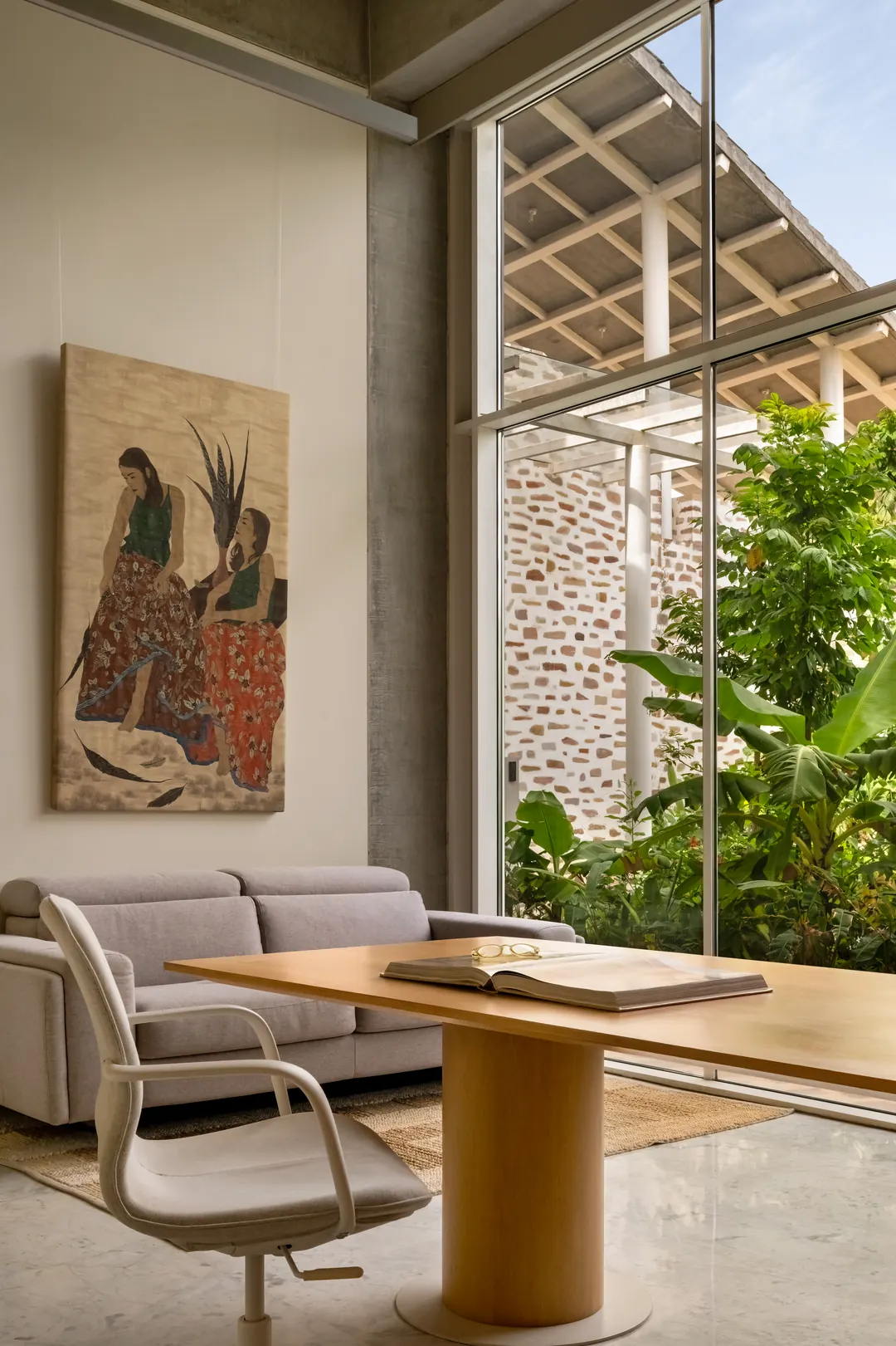 A figurative painting above a reading corner at Oxygen.