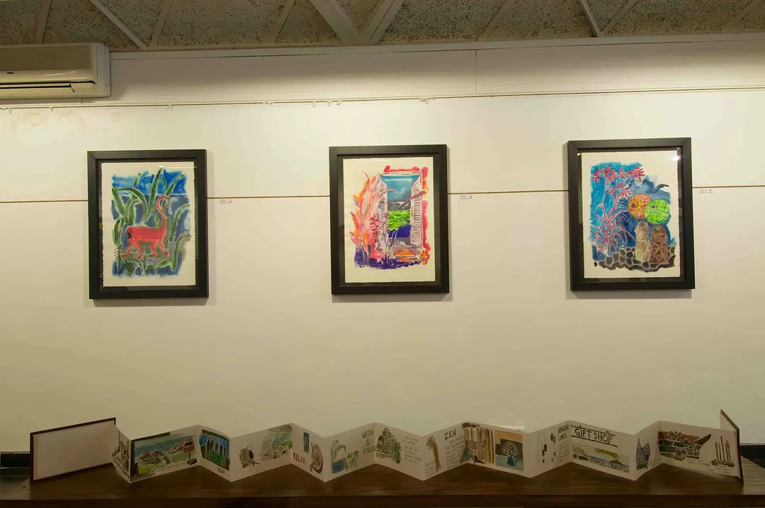 Three of Hiren Patel's paintings on a gallery wall.