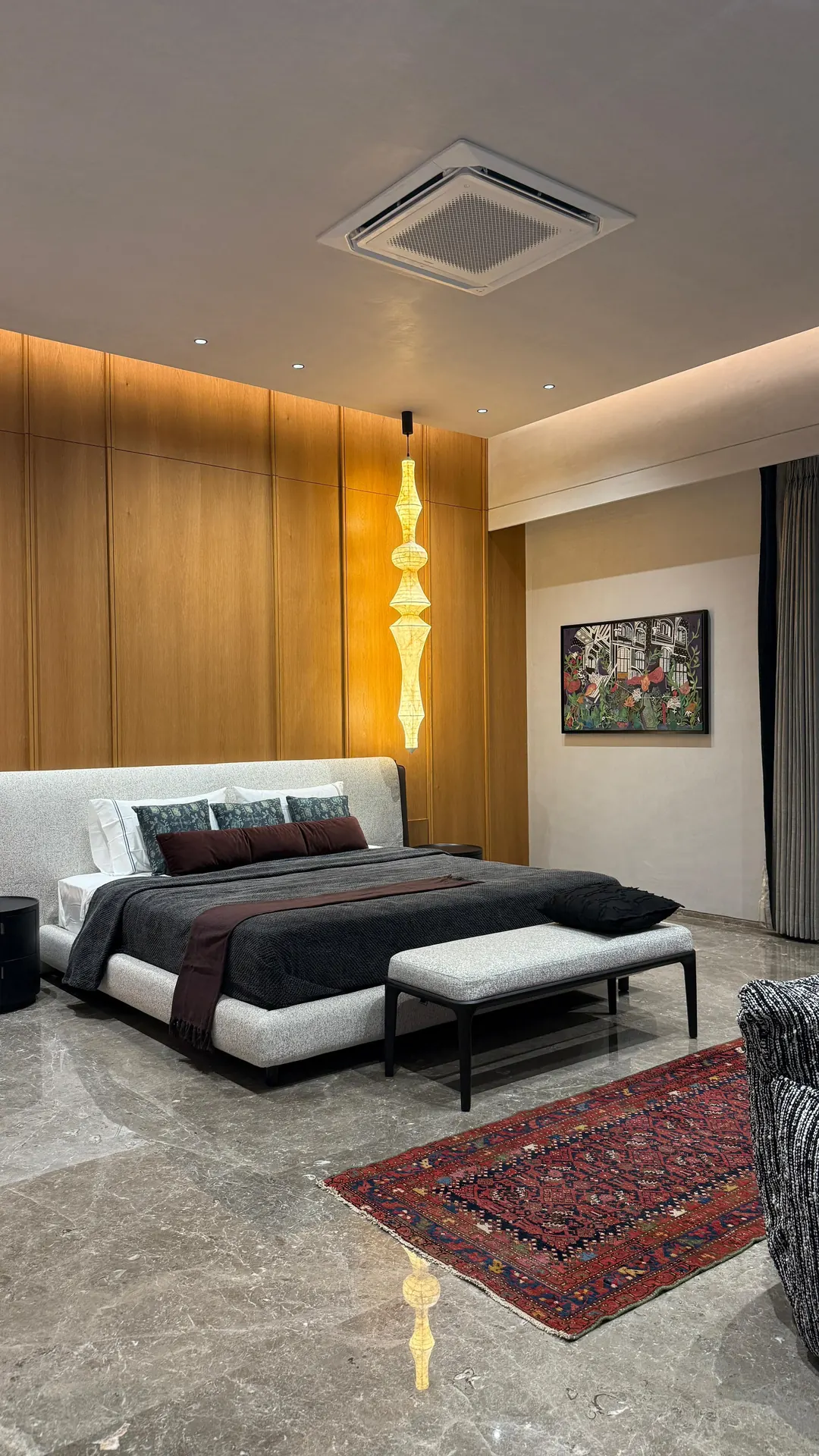 A bedroom handed over: timber, a lit niche, a rug.