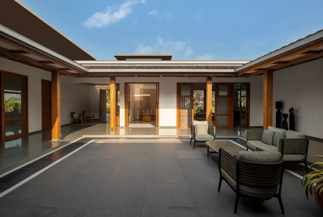 A courtyard open to the sky, deep timber verandahs on every side.