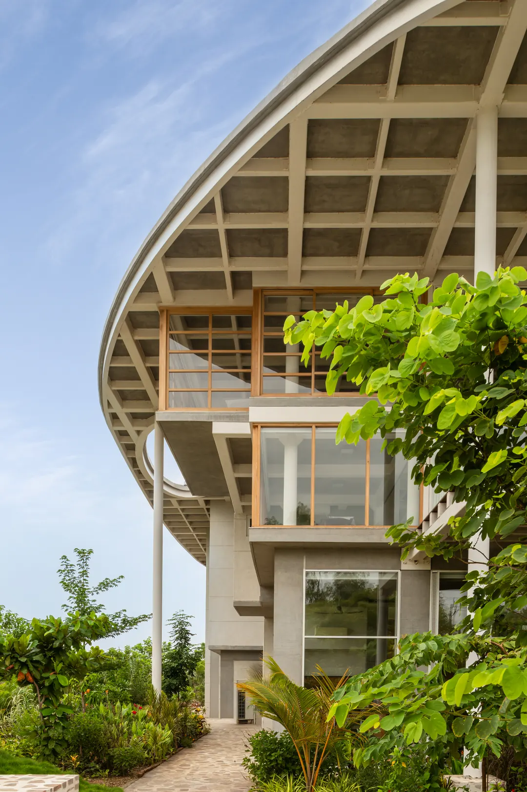 The coffered roof's curved edge against the sky, trees below.