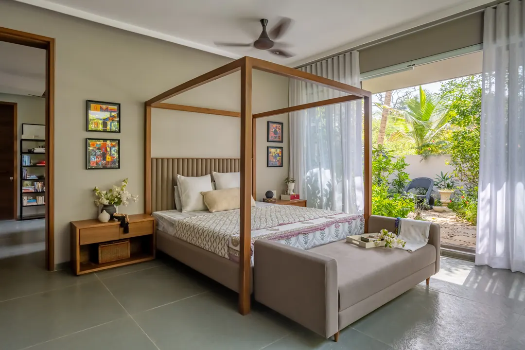 A canopy bed, sheer curtains to the garden.