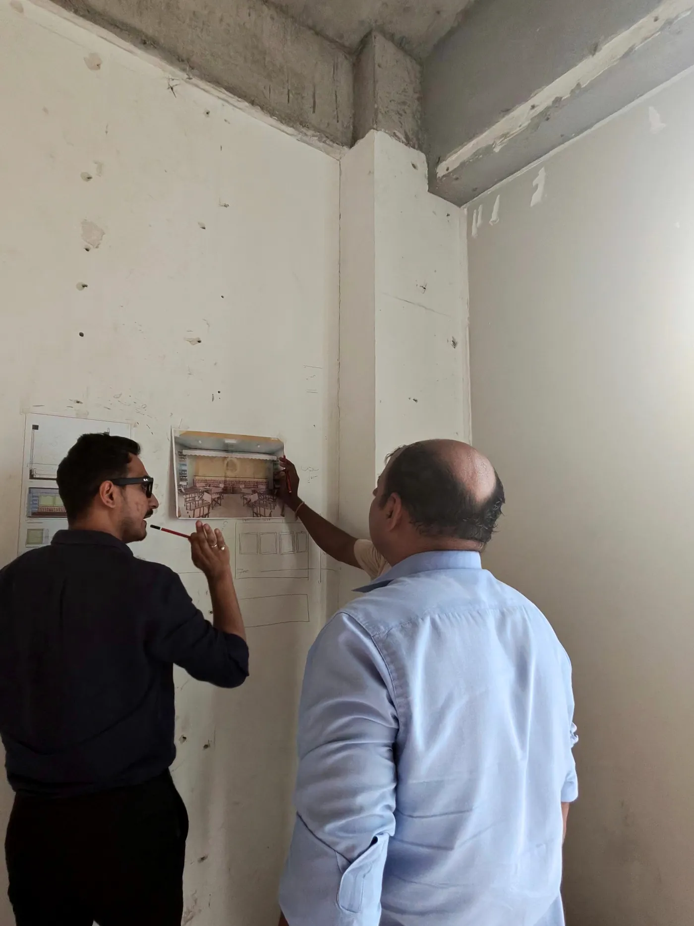 On site, the drawing pinned to a raw concrete wall and checked by hand.